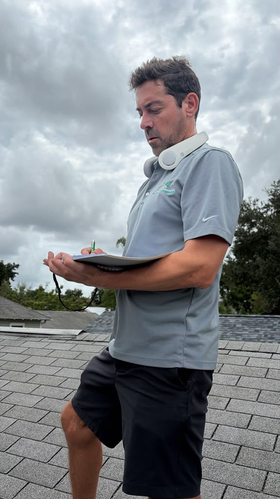 JA Edwards of America inspector on a residential roof with a clipboard documenting condition